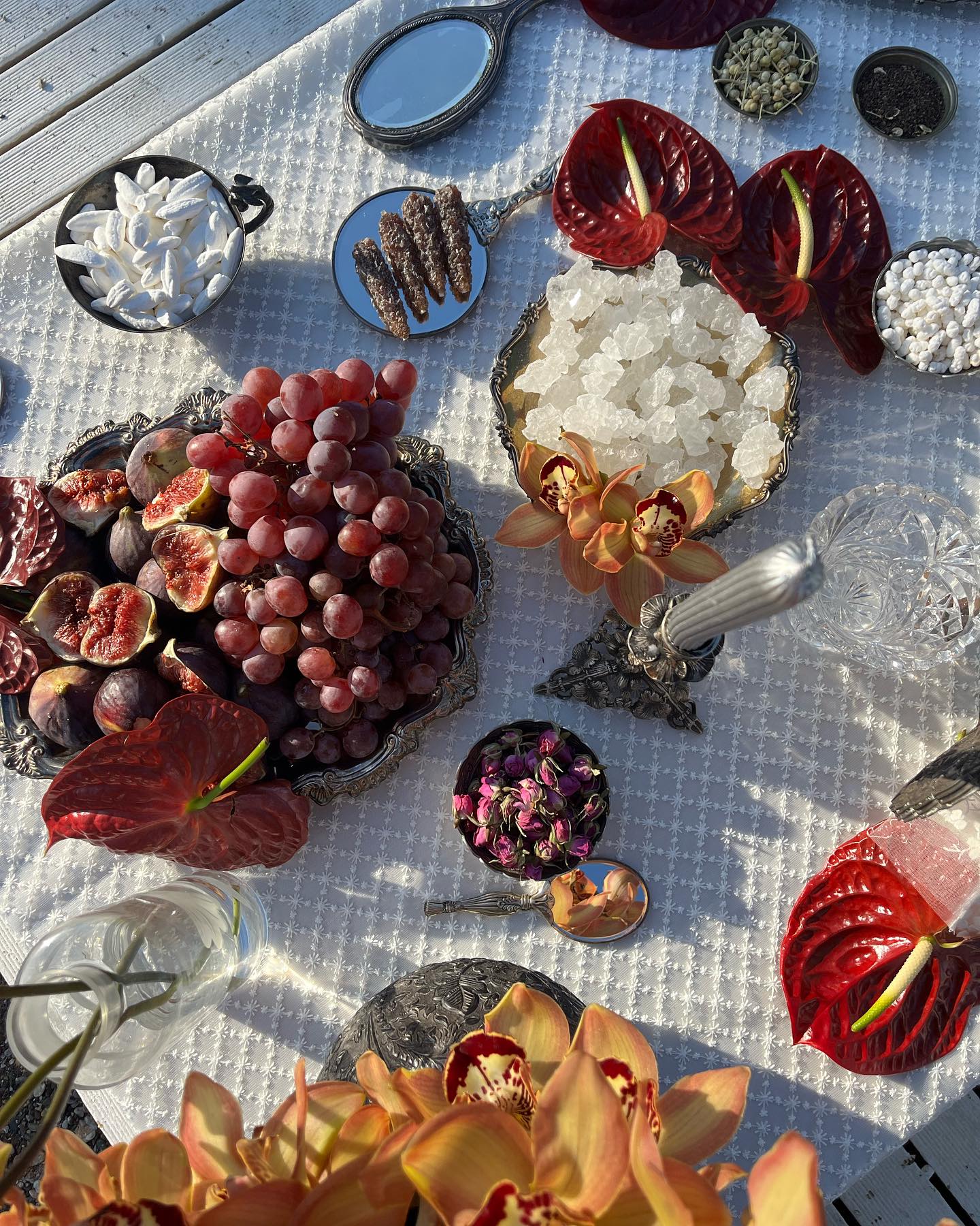 A table set with anthuriums and fruit