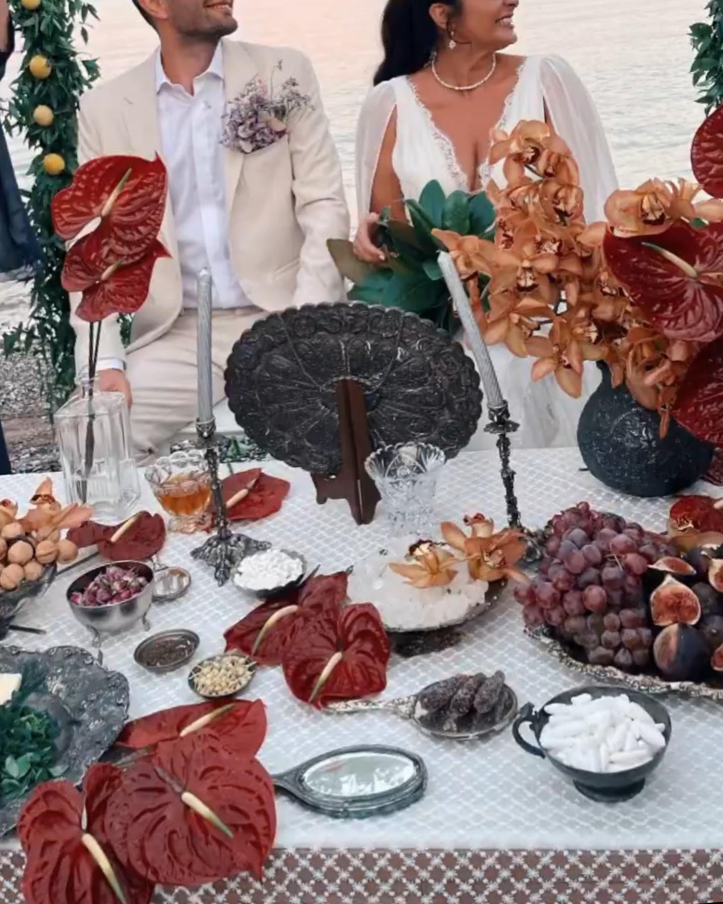 Guests around a table with flowers and candles
