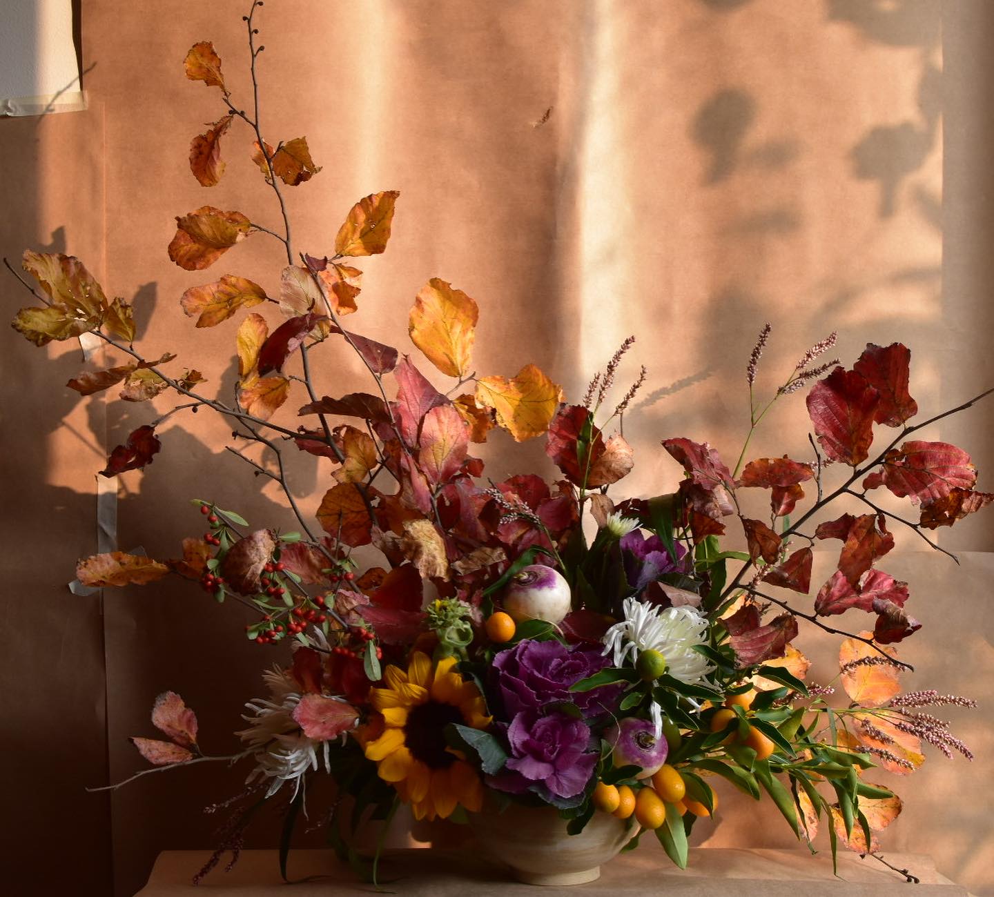 Autumn arrangement before a copper drape